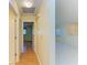 Bright hallway with wood floors leads to an open floor plan and bedroom at 4313 Carol Ann Rd # 20, Sarasota, FL 34233