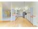 Well-lit kitchen with light cabinets, and views into a spacious living and dining area at 4313 Carol Ann Rd # 20, Sarasota, FL 34233