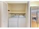 Laundry room with a modern washer and dryer, and built-in shelving at 4313 Carol Ann Rd # 20, Sarasota, FL 34233