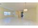 Spacious living room with tile floors, chandelier, and lots of windows at 4313 Carol Ann Rd # 20, Sarasota, FL 34233