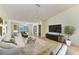 Bright living room with sliding glass doors to the lanai, and light wood flooring at 4313 Carol Ann Rd # 20, Sarasota, FL 34233