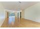 Bright living room featuring wood floors and a sliding glass door that provides lots of natural light at 4313 Carol Ann Rd # 20, Sarasota, FL 34233