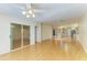 Open-concept living room with hardwood floors, ceiling fan, and access to kitchen at 4313 Carol Ann Rd # 20, Sarasota, FL 34233