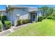 Well-maintained side yard with lush greenery and a screened entryway, adding privacy and charm at 4313 Carol Ann Rd # 20, Sarasota, FL 34233