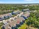 Aerial view showing multiple blue townhomes nestled within a lush, green community at 4548 Chinkapin Dr, Sarasota, FL 34232