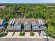 An aerial view of townhomes showcasing a lovely green landscape and pond at 4548 Chinkapin Dr, Sarasota, FL 34232