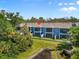 A beautiful view of the rear of the townhomes with balconies overlooking a tranquil pond at 4548 Chinkapin Dr, Sarasota, FL 34232