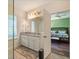 Bathroom has double sinks and a large mirror and looks into the primary bedroom at 4548 Chinkapin Dr, Sarasota, FL 34232