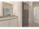 Bright bathroom with granite vanity, white cabinets, and shower with curtain at 4548 Chinkapin Dr, Sarasota, FL 34232