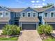 Attractive two-story townhome featuring a two-car garage and charming landscaping at 4548 Chinkapin Dr, Sarasota, FL 34232