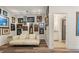 Hallway area with artwork, sofa, and entryway to the bathroom at 4548 Chinkapin Dr, Sarasota, FL 34232