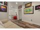 Hallway with wood floors, white walls, Disney themed art and a red chair at 4548 Chinkapin Dr, Sarasota, FL 34232