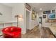 Hallway area featuring a comfortable chair, artwork, and hardwood floors at 4548 Chinkapin Dr, Sarasota, FL 34232