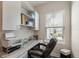 Bright office features built-in cabinets, shelving, modern desk and large window at 4548 Chinkapin Dr, Sarasota, FL 34232
