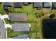 An aerial shot showcases a beautiful backyard with a lush lawn and a tranquil pond at 4815 Deep Creek Ter, Parrish, FL 34219