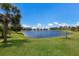 Lush green lawn meets a peaceful lake, creating a serene backyard oasis at 4815 Deep Creek Ter, Parrish, FL 34219