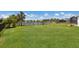 Large backyard with lush green grass and a tranquil lake view, perfect for outdoor enjoyment at 4815 Deep Creek Ter, Parrish, FL 34219