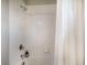 Bathtub and shower combination featuring white tile and chrome hardware at 4815 Deep Creek Ter, Parrish, FL 34219