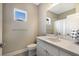 Bright bathroom featuring a single vanity, large mirror, and toilet at 4815 Deep Creek Ter, Parrish, FL 34219