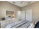 Comfortable bedroom features a white dresser with a large mirror and a blue-patterned comforter at 4815 Deep Creek Ter, Parrish, FL 34219