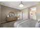 Serene bedroom with a large dresser, modern lighting, and en-suite bathroom access at 4815 Deep Creek Ter, Parrish, FL 34219