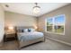 Bright bedroom boasts a stylish bed frame and a sun-filled window with views of lush greenery at 4815 Deep Creek Ter, Parrish, FL 34219