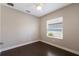 Serene bedroom with wood-look flooring, base molding, and a bright window offering natural light and neutral paint at 4815 Deep Creek Ter, Parrish, FL 34219