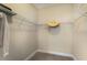 Spacious walk-in closet with carpet floor, wire shelving and a hat hanging from one of the shelves at 4815 Deep Creek Ter, Parrish, FL 34219