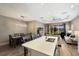 Open floor plan showcasing kitchen with island, adjacent dining area, and living room with sliding glass doors at 4815 Deep Creek Ter, Parrish, FL 34219