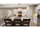 Open-concept kitchen with white cabinets, quartz counters, stainless appliances, and seamless flow to the living area at 4815 Deep Creek Ter, Parrish, FL 34219