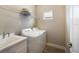 Well-equipped laundry room with modern washer, dryer, sink, and wire shelving at 4815 Deep Creek Ter, Parrish, FL 34219