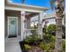 Inviting front porch with a charming door, lovely wreath, and carefully landscaped garden at 4815 Deep Creek Ter, Parrish, FL 34219