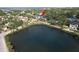 Aerial view of the home with a large pond in the foreground and lush green trees surrounding the property at 4815 W Sunset Blvd, Tampa, FL 33629