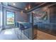 Stylish entertainment bar with granite counters, seating, wine refrigerator and view of the outdoors at 4815 W Sunset Blvd, Tampa, FL 33629