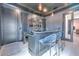 Entertainment bar with granite counters, seating, TV, wine refrigerator and custom cabinetry at 4815 W Sunset Blvd, Tampa, FL 33629
