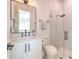 Elegant bathroom with marble shower, framed mirror, and white vanity providing a bright, clean aesthetic at 4815 W Sunset Blvd, Tampa, FL 33629