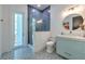 Modern bathroom with blue herringbone tiled shower and decorative patterned tile flooring at 4815 W Sunset Blvd, Tampa, FL 33629
