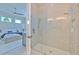 Sleek bathroom featuring a glass shower enclosure and a glimpse into the adjacent bedroom at 4815 W Sunset Blvd, Tampa, FL 33629