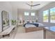 Serene bedroom with accent wall, modern ceiling fan, large windows, and plush white rug at 4815 W Sunset Blvd, Tampa, FL 33629
