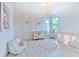 Adorable Bedroom with a crib, accent wall, and plush toys, bathed in natural light from large windows at 4815 W Sunset Blvd, Tampa, FL 33629