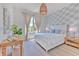Comfortable bedroom with hardwood floors, designer wallpaper, natural light and stylish woven pendant lamp at 4815 W Sunset Blvd, Tampa, FL 33629