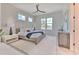 Serene bedroom with accent wall, modern ceiling fan, large windows, and plush white rug at 4815 W Sunset Blvd, Tampa, FL 33629