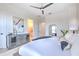 Bright bedroom featuring a dresser, closet and adjacent bathroom with natural light throughout at 4815 W Sunset Blvd, Tampa, FL 33629