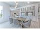 Elegant dining room with large windows and view to adjoining living room at 4815 W Sunset Blvd, Tampa, FL 33629