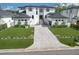 Stunning new construction home featuring a modern design, manicured lawn, and elegant paver driveway at 4815 W Sunset Blvd, Tampa, FL 33629