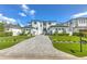 Striking modern home with lush front lawn, gorgeous landscaping, and a lengthy paver driveway at 4815 W Sunset Blvd, Tampa, FL 33629