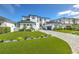 Beautiful modern home with a manicured lawn, elegant landscaping, and a long driveway at 4815 W Sunset Blvd, Tampa, FL 33629