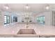 Modern open-concept kitchen and living area with tile floors, pendant lighting, and sleek appliances at 4815 W Sunset Blvd, Tampa, FL 33629