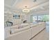 Bright living room boasts sleek tile flooring, plush seating, and sliding doors to the balcony at 4815 W Sunset Blvd, Tampa, FL 33629