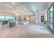 Open-concept living space with tile floors, modern lighting, and access to an outdoor balcony at 4815 W Sunset Blvd, Tampa, FL 33629
